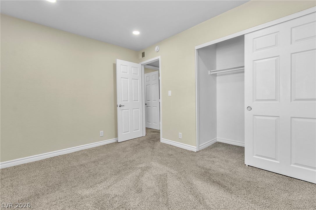 Plush carpeting and a spacious built-in closet anchor this versatile secondary bedroom.