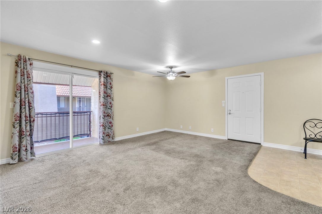 Plush carpeting and durable tile flooring meet in this versatile, open living area.