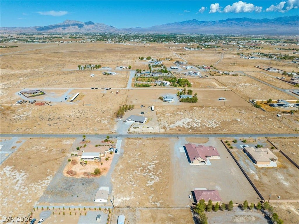 1641 W Huckleberry Street, Pahrump, NV 89048 Distant mountains frame a wide, open desert landscape with scattered homes.
