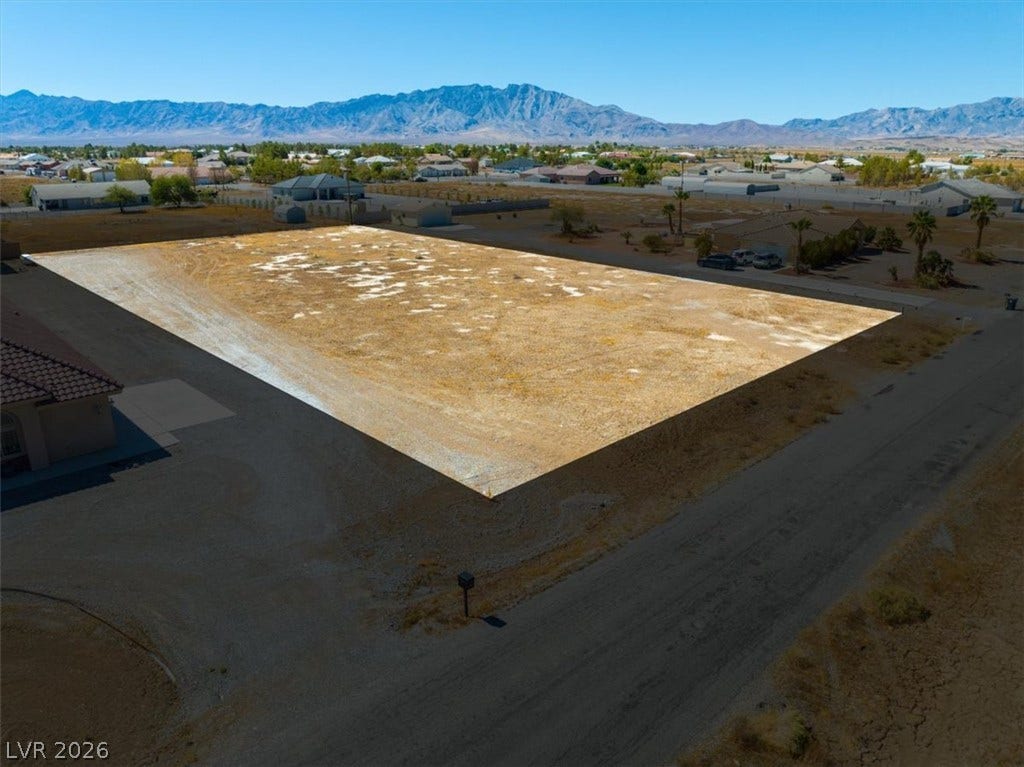 1641 W Huckleberry Street, Pahrump, NV 89048 Dramatic mountain peaks frame this expansive, level desert homesite waiting for custom development.