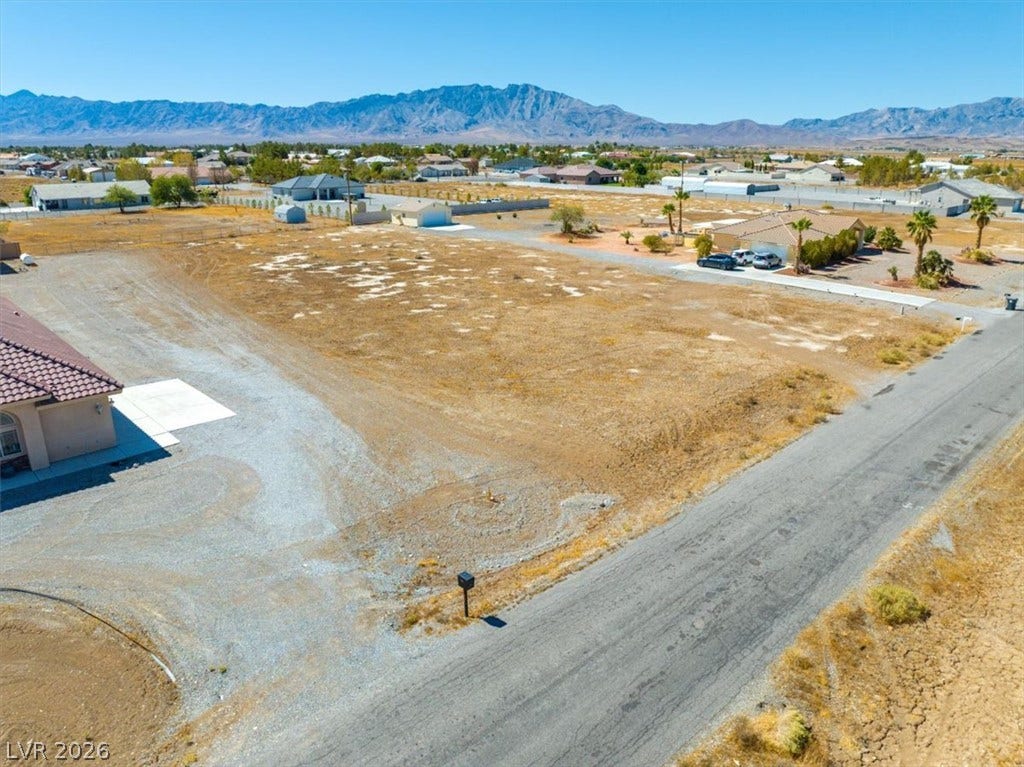 1641 W Huckleberry Street, Pahrump, NV 89048 A spacious vacant lot sits ready for development against a majestic mountain backdrop.