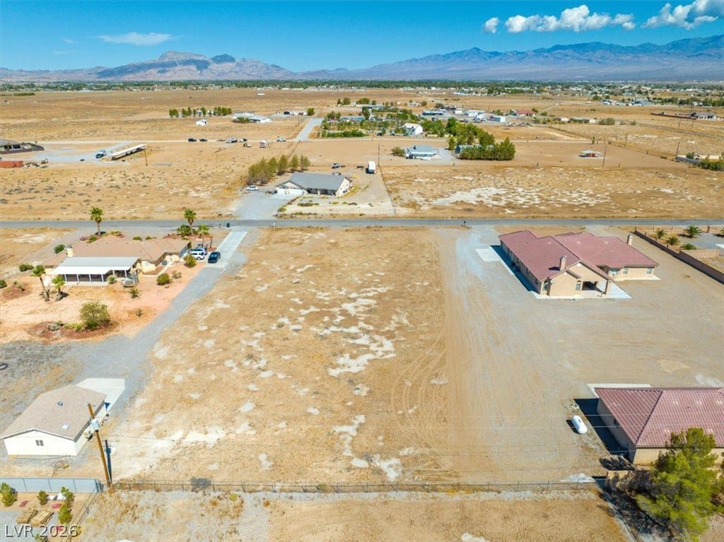 1641 W Huckleberry Street, Pahrump, NV 89048 An aerial perspective captures a level desert building site framed by majestic mountain backdrops.