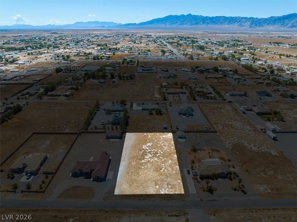 1641 W Huckleberry Street, Pahrump, NV 89048 An aerial perspective captures a level lot positioned against a backdrop of distant mountains.