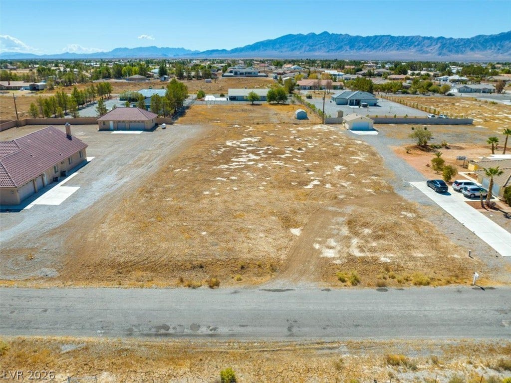 1641 W Huckleberry Street, Pahrump, NV 89048 A spacious vacant lot sits ready for development against a backdrop of distant mountains.
