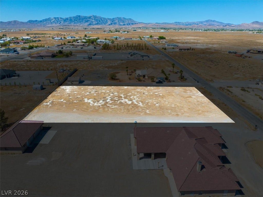 1641 W Huckleberry Street, Pahrump, NV 89048 An expansive level lot sits poised for development against a majestic mountain backdrop.