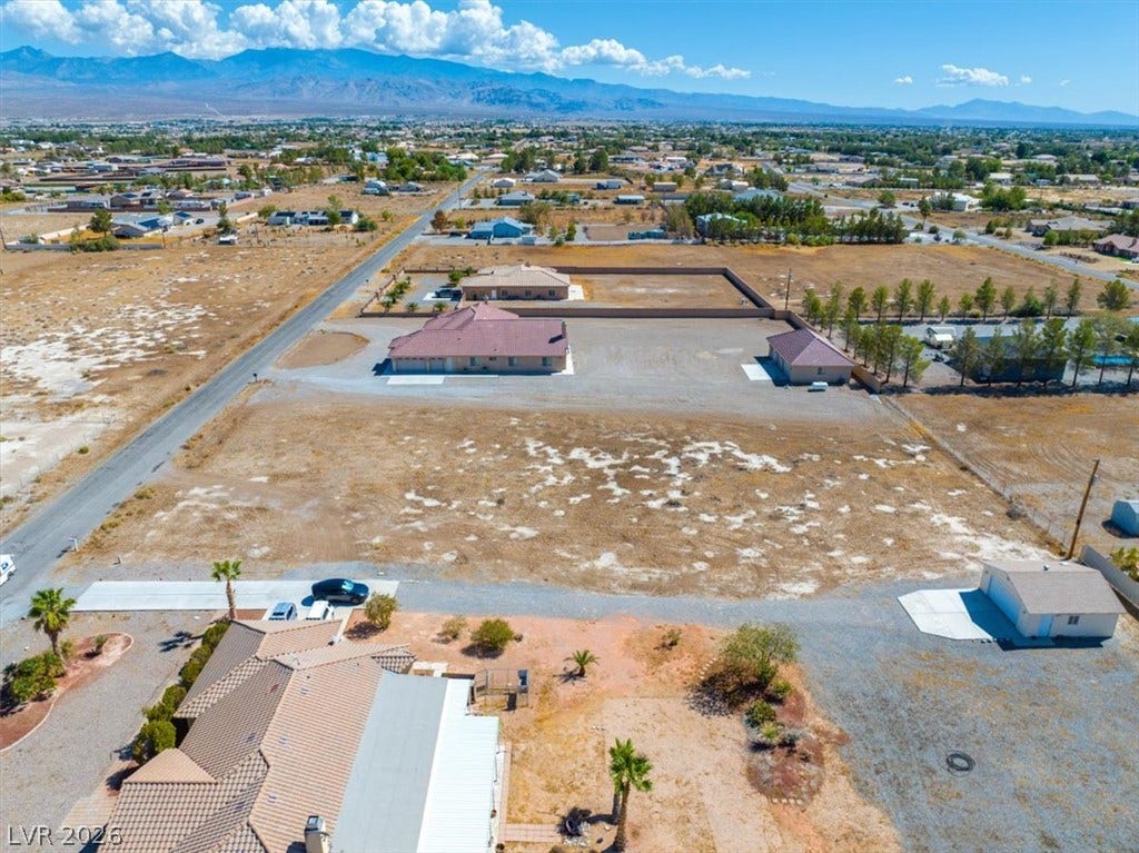 1641 W Huckleberry Street, Pahrump, NV 89048 An expansive desert lot presents clear mountain views under a bright blue sky.