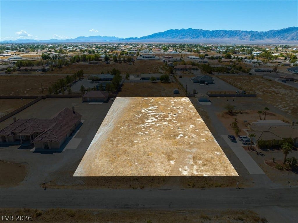 1641 W Huckleberry Street, Pahrump, NV 89048 An aerial perspective showcases a level building lot set against a majestic mountain backdrop.