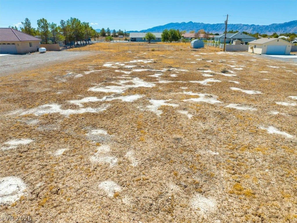 1641 W Huckleberry Street, Pahrump, NV 89048 A spacious level lot surrounded by distant mountain views and established neighborhood properties.