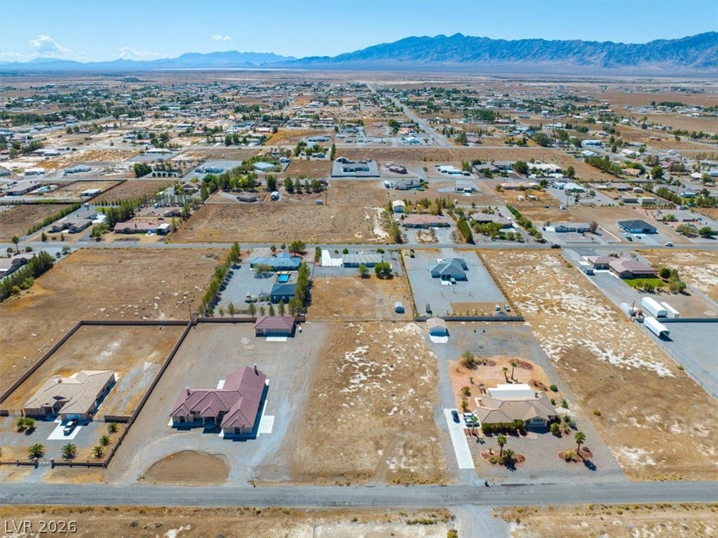 1641 W Huckleberry Street, Pahrump, NV 89048 Expansive desert surroundings frame this aerial view of the property and its mountain backdrop.