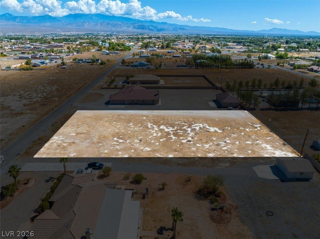 1641 W Huckleberry Street, Pahrump, NV 89048 A spacious vacant lot sits in a quiet neighborhood with panoramic mountain views.