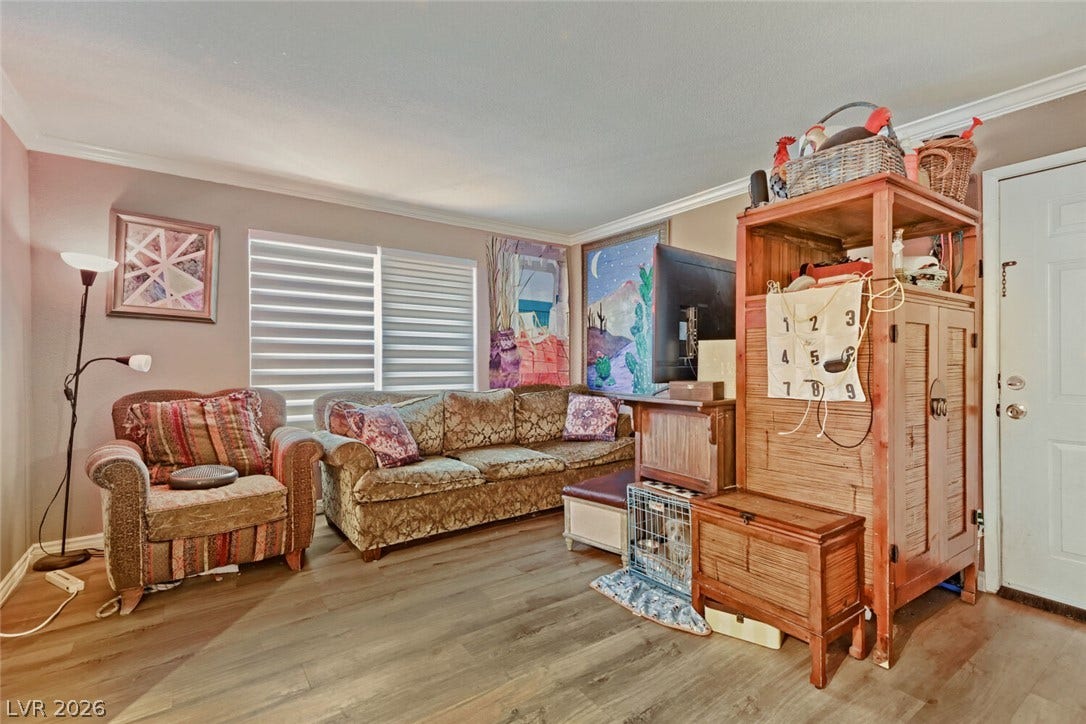 8101 W Flamingo Road, #1074, Las Vegas, NV 89147 Crown molding frames the versatile main living space finished with durable wood-look flooring.