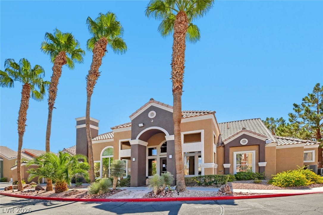 8101 W Flamingo Road, #1074, Las Vegas, NV 89147 Palm trees frame the arched entryway and tiled rooflines of this modern exterior design.