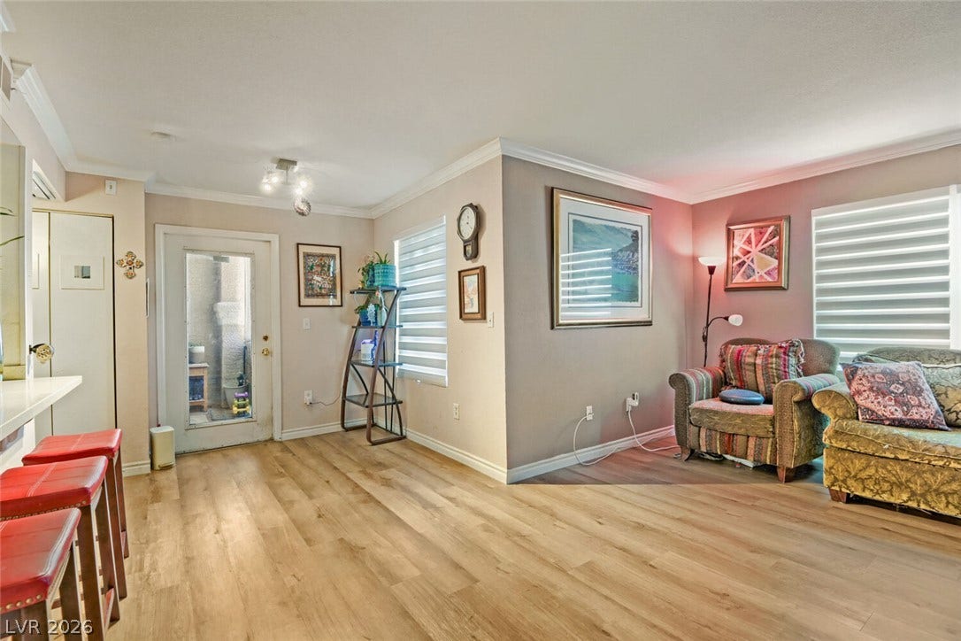8101 W Flamingo Road, #1074, Las Vegas, NV 89147 Smooth wood floors and crisp crown molding elevate this open-concept main-level living space.