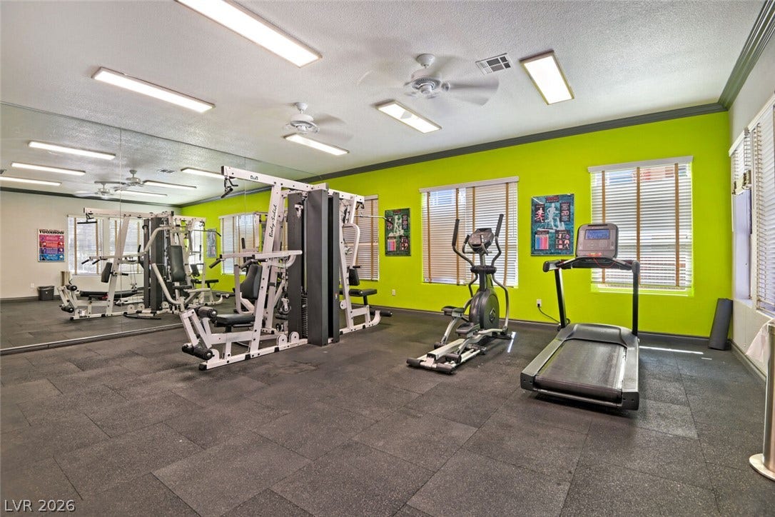 8101 W Flamingo Road, #1074, Las Vegas, NV 89147 A spacious fitness room features durable rubber flooring, mirrored walls, and multiple bright windows.