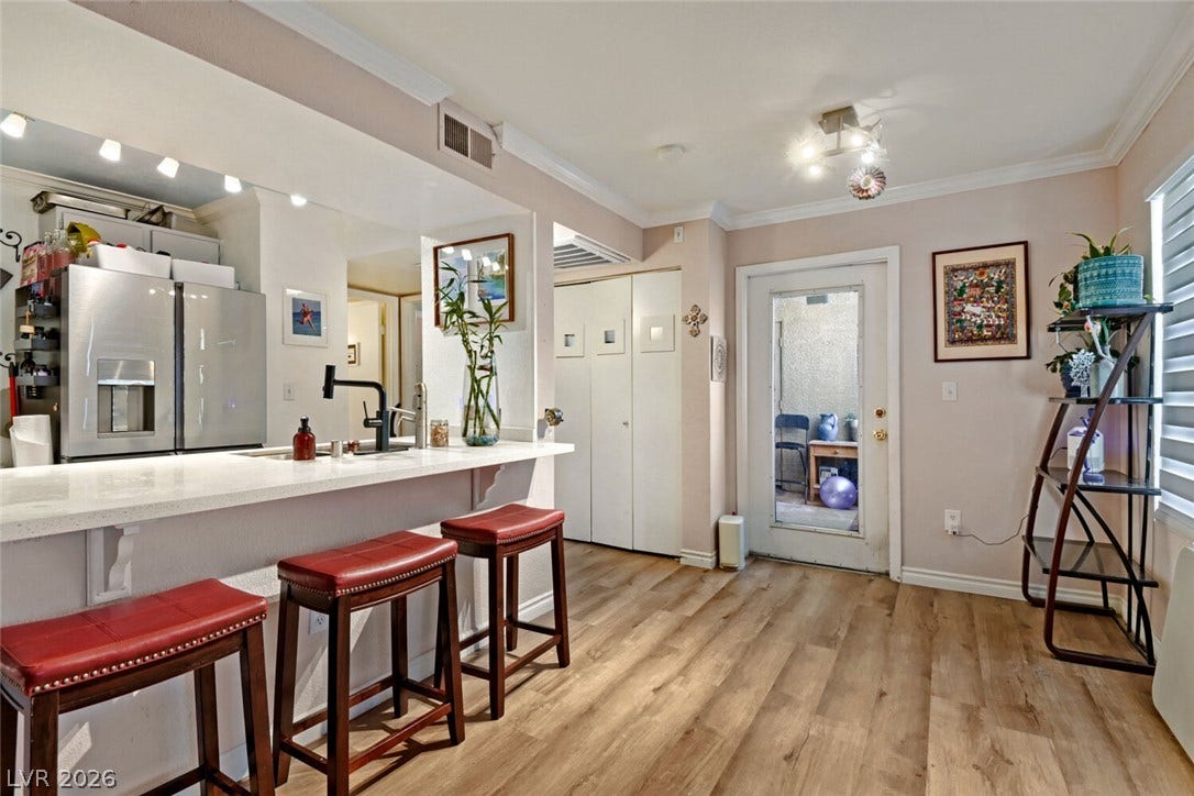 8101 W Flamingo Road, #1074, Las Vegas, NV 89147 Rich wood-look flooring and a raised breakfast bar anchor this versatile dining space.