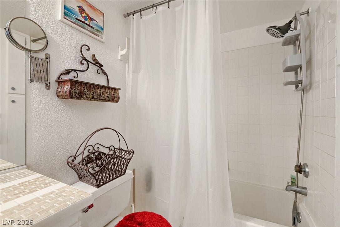 8101 W Flamingo Road, #1074, Las Vegas, NV 89147 Crisp tiled walls line the shower and tub area in this classic bathroom space.
