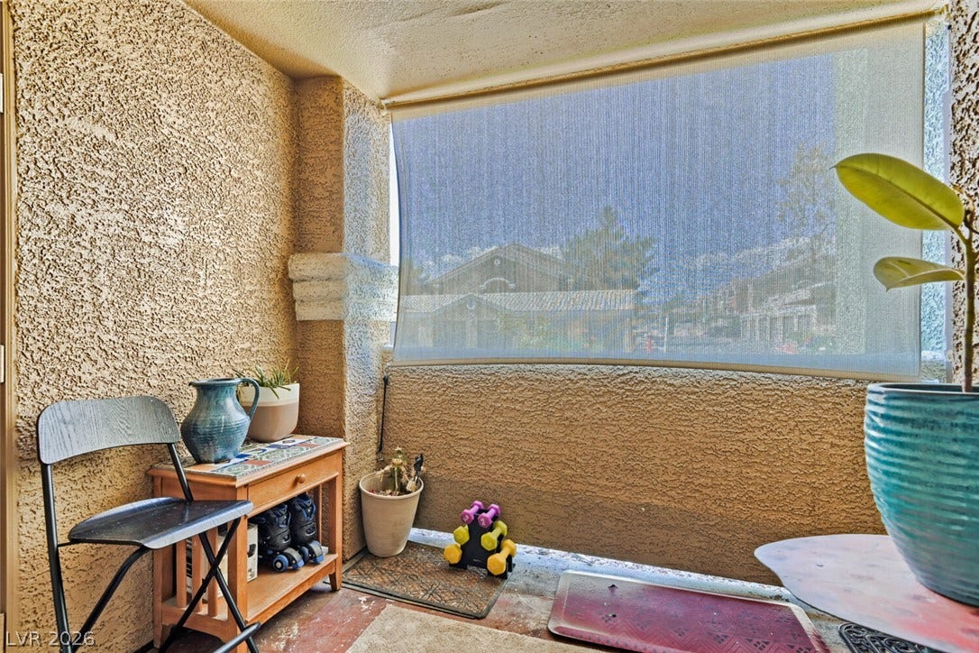 8101 W Flamingo Road, #1074, Las Vegas, NV 89147 A private covered patio featuring stucco walls and concrete flooring offers an inviting outdoor retreat.