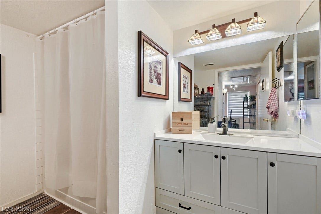 8101 W Flamingo Road, #1074, Las Vegas, NV 89147 Modern cabinetry and clean solid-surface countertops define this updated bathroom space.