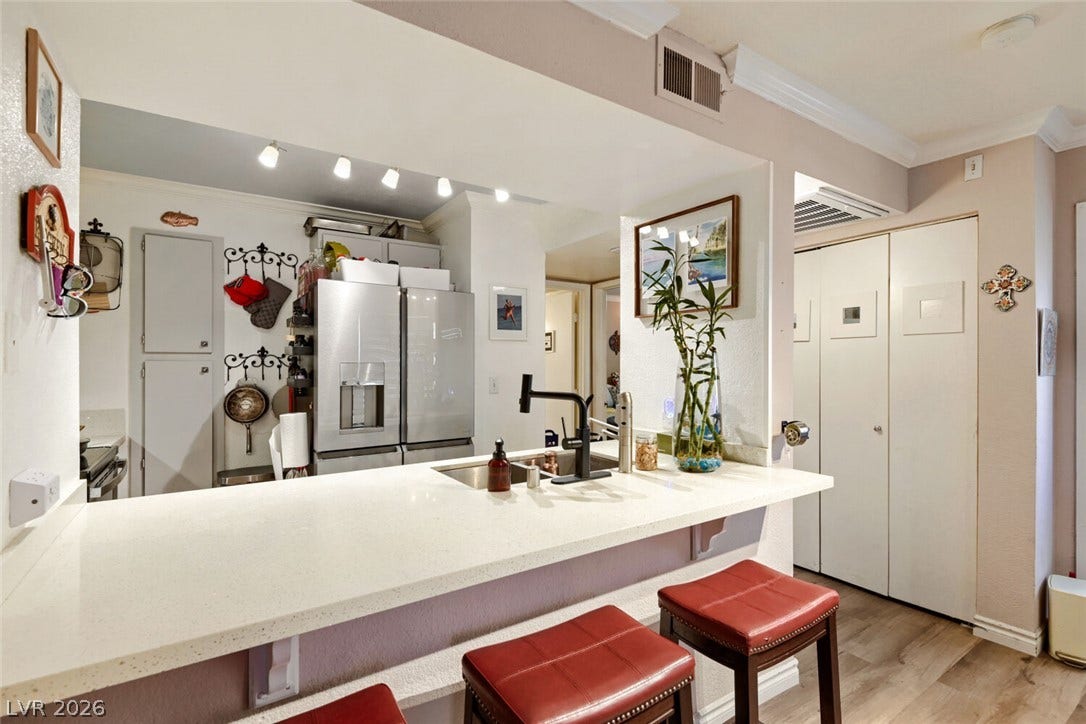 8101 W Flamingo Road, #1074, Las Vegas, NV 89147 An open pass-through breakfast bar integrates the kitchen seamlessly with the surrounding living space.