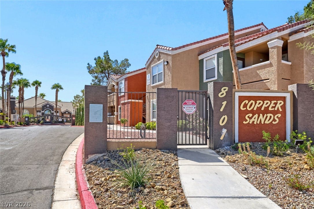 8101 W Flamingo Road, #1074, Las Vegas, NV 89147 Gated entry pathways showcase the Mediterranean-inspired architecture and desert landscaping.