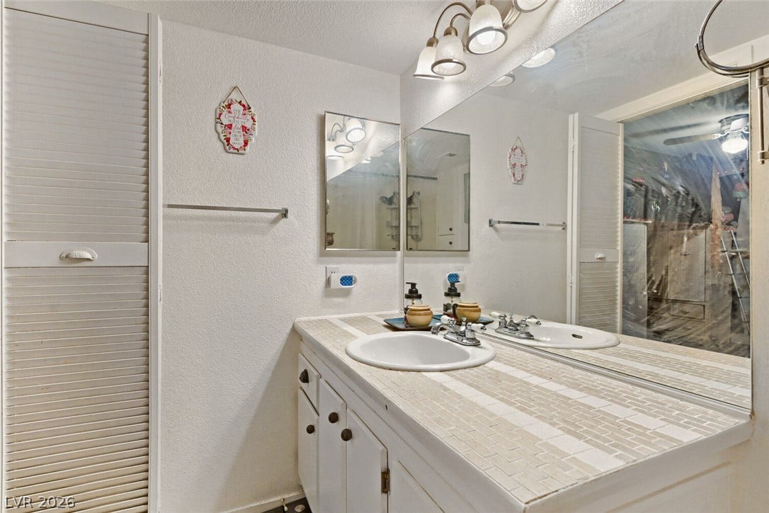 8101 W Flamingo Road, #1074, Las Vegas, NV 89147 Tiled countertops and white cabinetry complete this functional bathroom space.