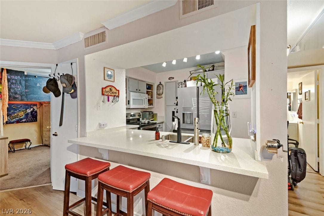 8101 W Flamingo Road, #1074, Las Vegas, NV 89147 An open pass-through breakfast bar connects the living space directly to the kitchen.