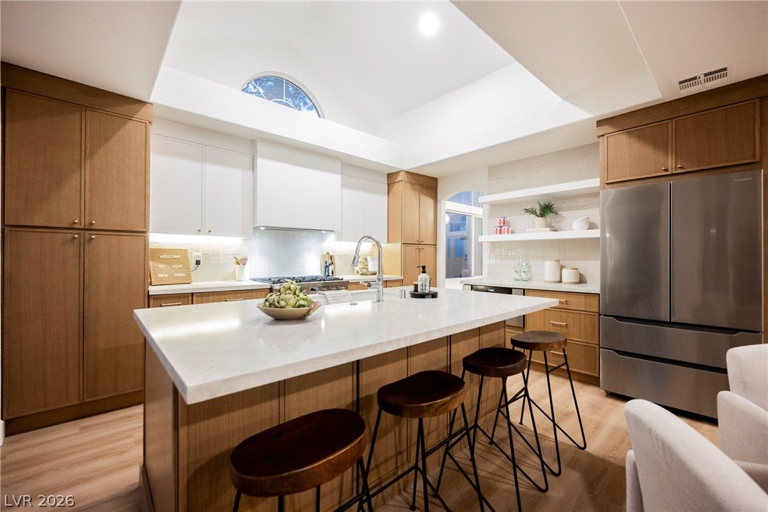 A vaulted ceiling and a central island highlight this beautifully crafted kitchen space.
