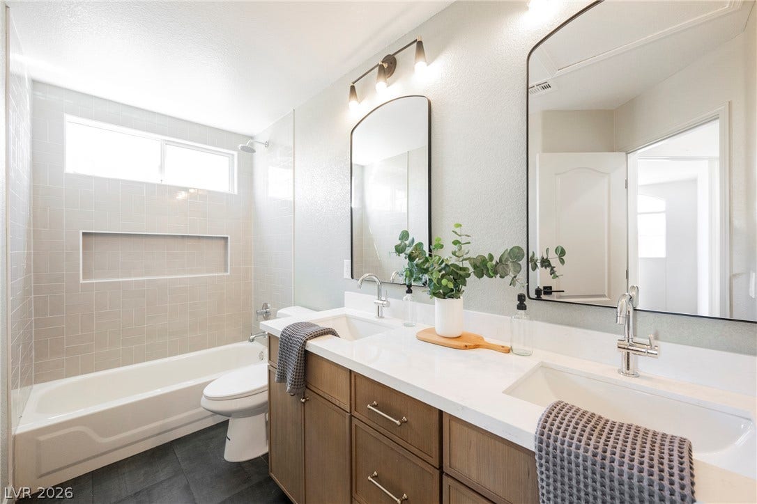 Clean lines and a spacious dual vanity define this updated bathroom layout.