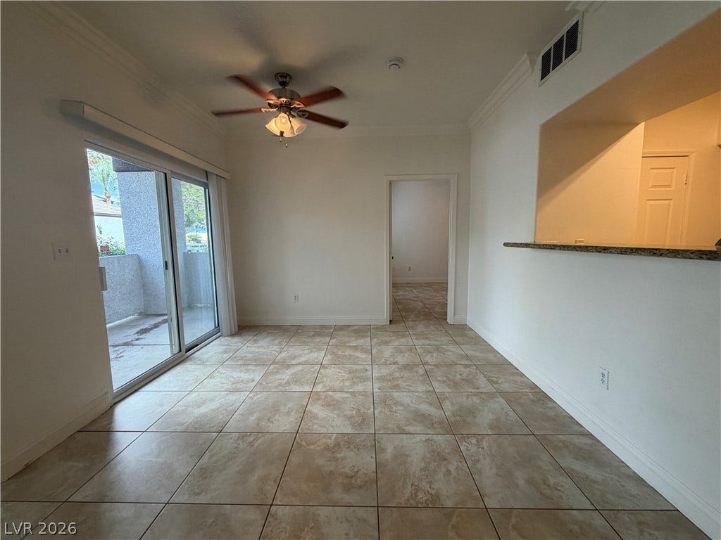 7255 W Sunset Road, #1167, Las Vegas, NV 89113 Tile flooring and sliding glass doors leading outside define this versatile open dining area.