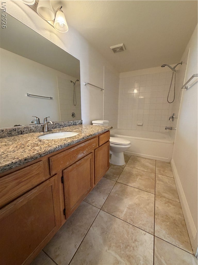 7255 W Sunset Road, #1167, Las Vegas, NV 89113 Granite counters and tiled flooring enhance the functional layout of this bathroom.