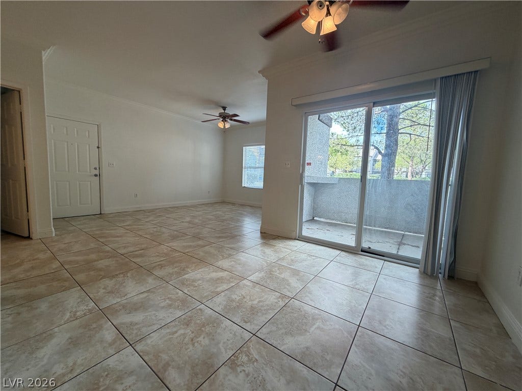 7255 W Sunset Road, #1167, Las Vegas, NV 89113 Sliding glass doors open to a private balcony from this spacious tiled living area.