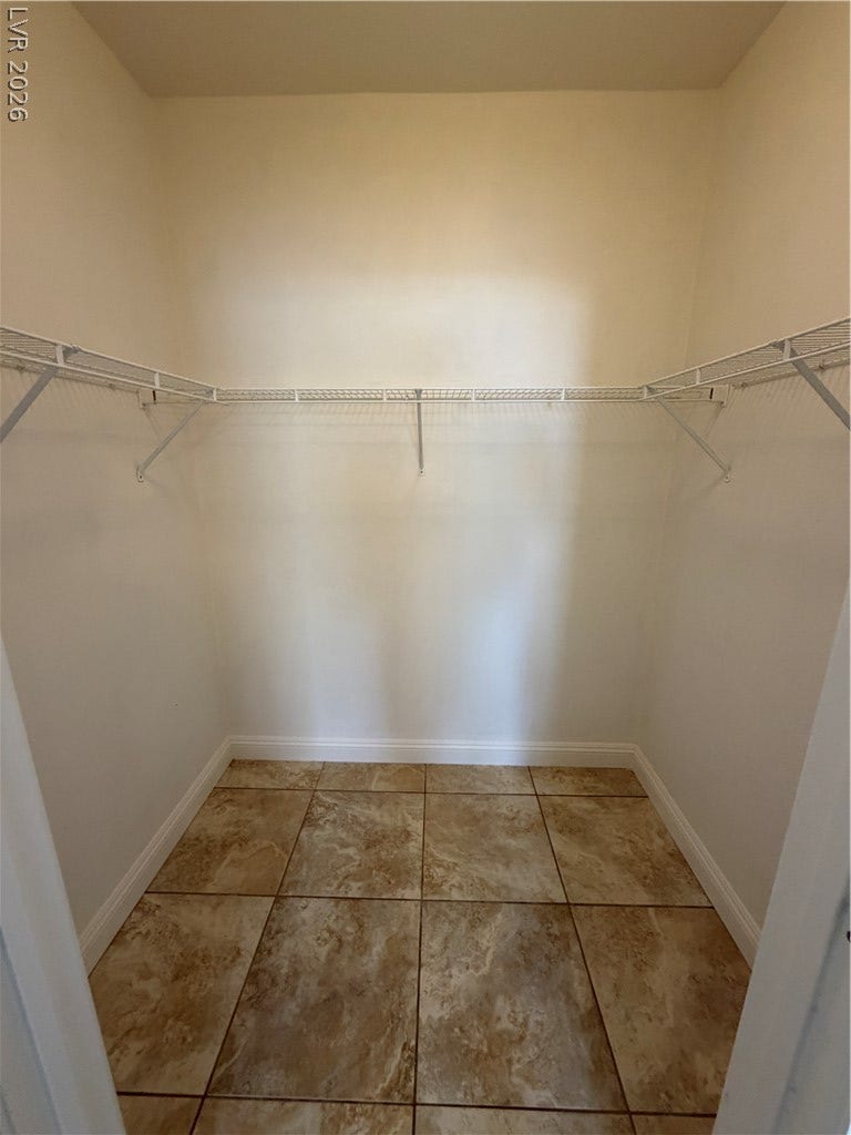 7255 W Sunset Road, #1167, Las Vegas, NV 89113 Tiled flooring and built-in wire shelving maximize storage potential in this walk-in closet.