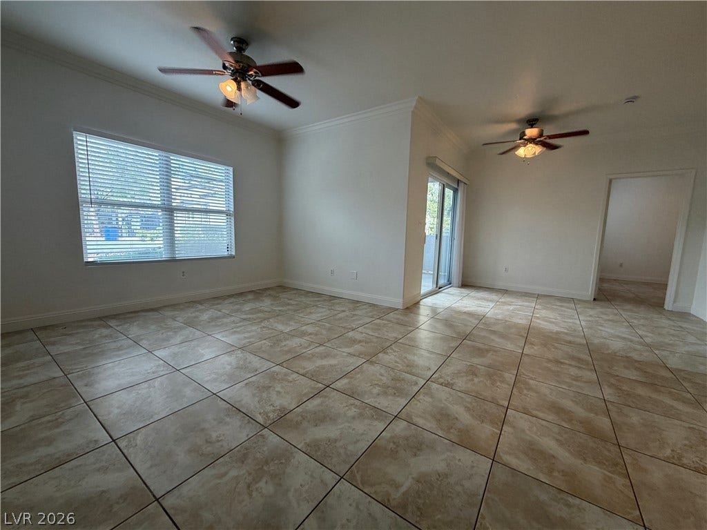 7255 W Sunset Road, #1167, Las Vegas, NV 89113 An open floorplan shows tiled flooring beneath crown molding and a large window.