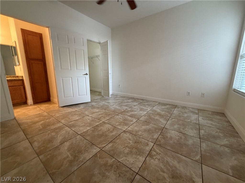7255 W Sunset Road, #1167, Las Vegas, NV 89113 Durable tile flooring spans this versatile bedroom featuring a walk-in closet and adjacent bath access.