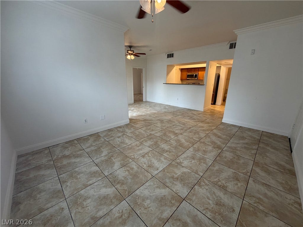 7255 W Sunset Road, #1167, Las Vegas, NV 89113 Tiled flooring and crown molding flow through the versatile, open-concept living space.