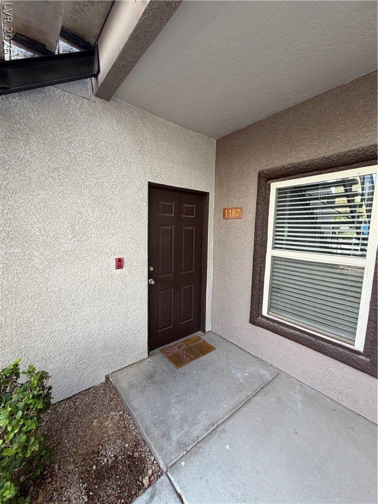 7255 W Sunset Road, #1167, Las Vegas, NV 89113 A welcoming private entrance framed by stucco finishes and concrete flooring leads into the home.
