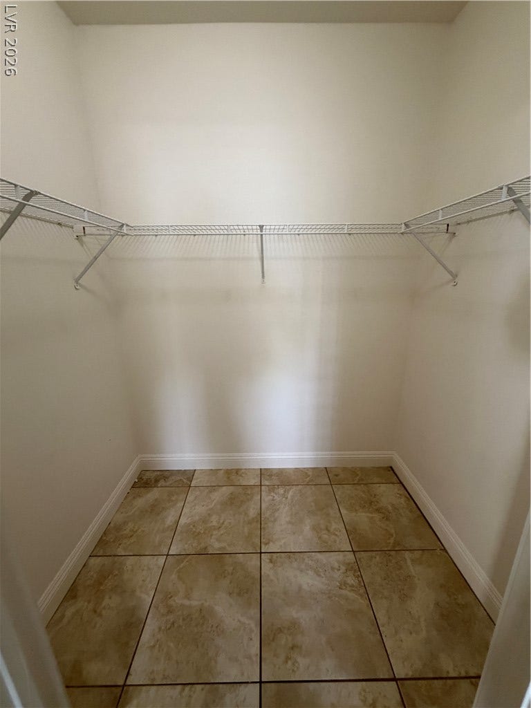 7255 W Sunset Road, #1167, Las Vegas, NV 89113 Tiled flooring and built-in wire shelving maximize organization in this storage space.