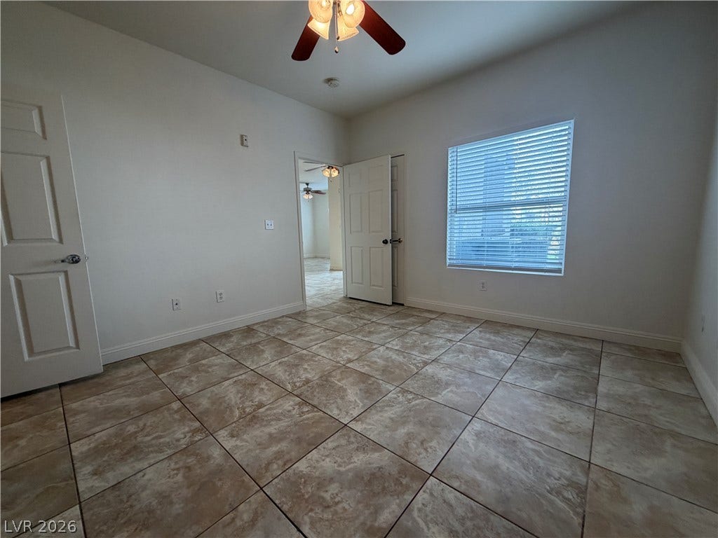 7255 W Sunset Road, #1167, Las Vegas, NV 89113 Textured tile flooring and a large window bring natural light into this versatile room.