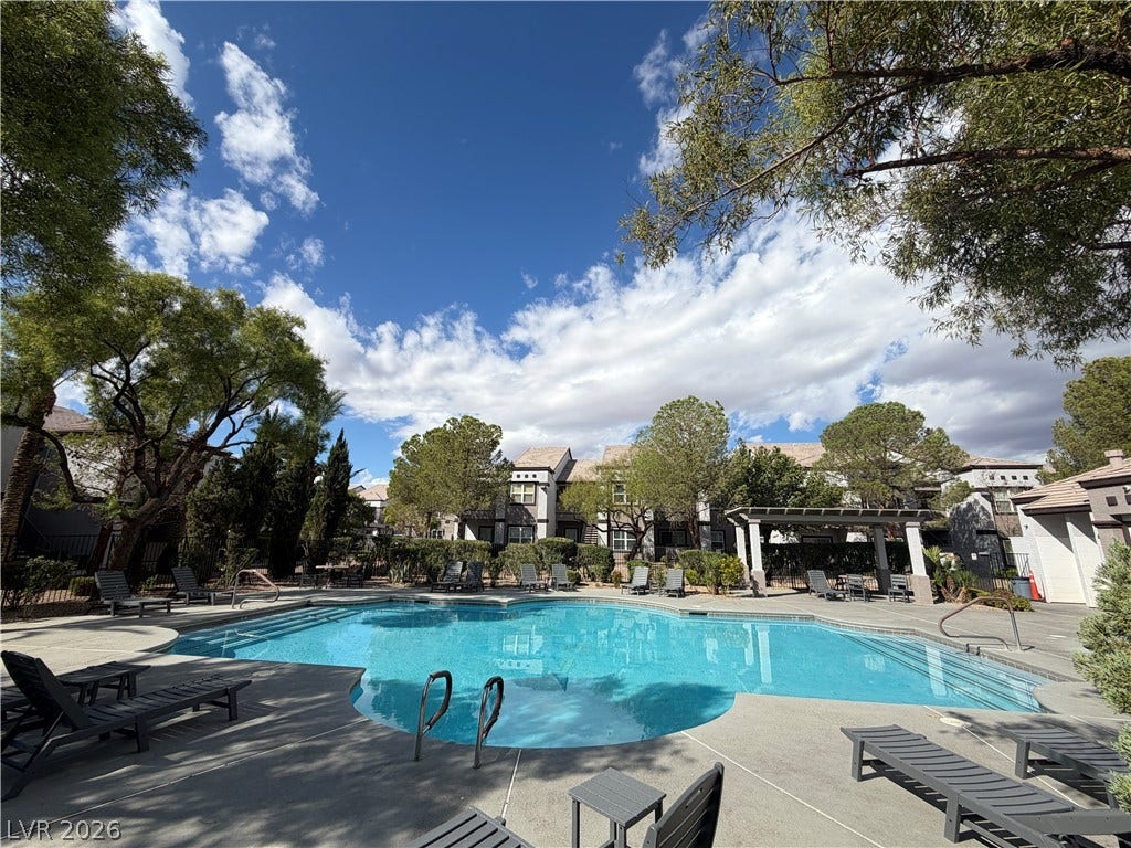 7255 W Sunset Road, #1167, Las Vegas, NV 89113 A sparkling community swimming pool rests under blue skies and mature shade trees.