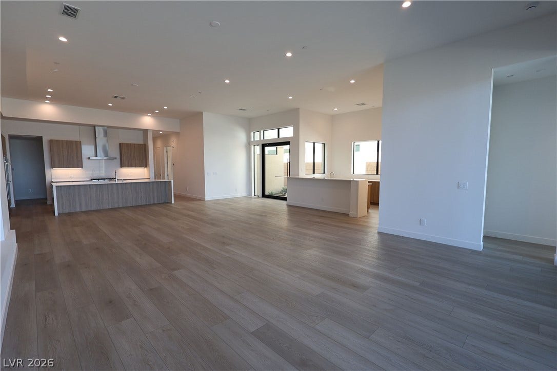 Gleaming hardwood floors and recessed lighting flow through this spacious open concept interior.
