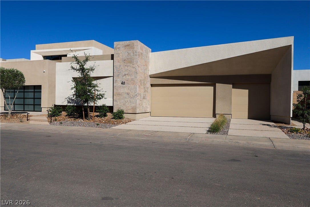 Bold geometric angles and textured stone elements define this contemporary desert facade.