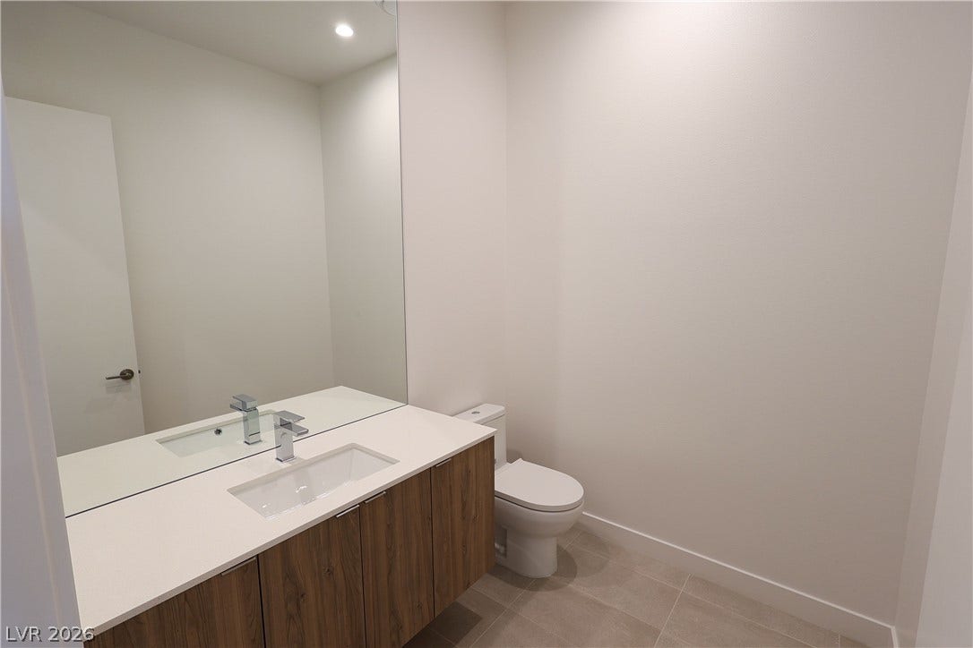 Clean lines and stone counters highlight this modern half bath.