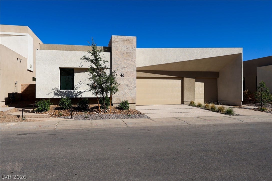 Clean lines and geometric angles define this striking modern home facade with an attached garage.