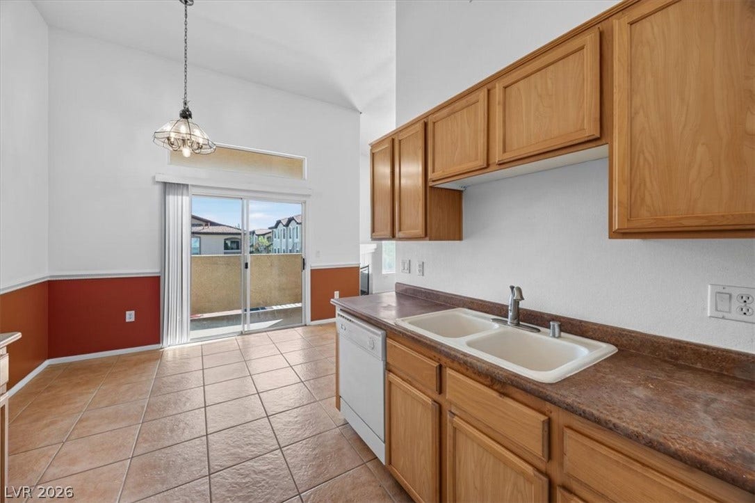 High ceilings and tiled flooring elevate this kitchen space opening directly to the outdoors.