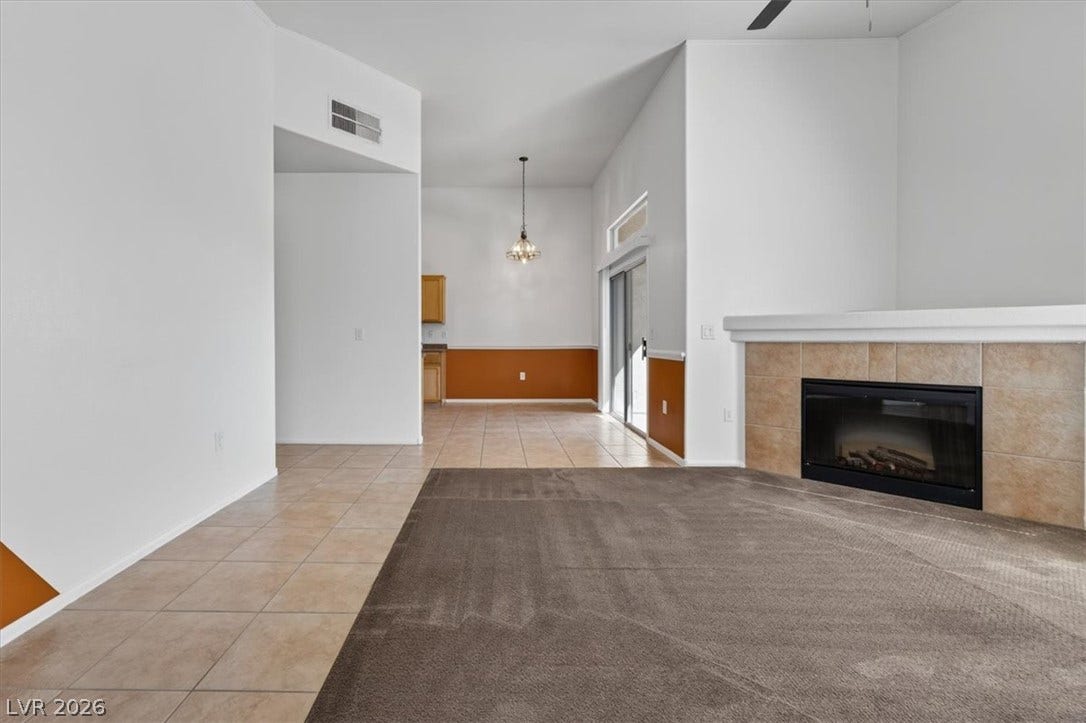 An open floorplan seamlessly connects the living space to the adjacent dining area.