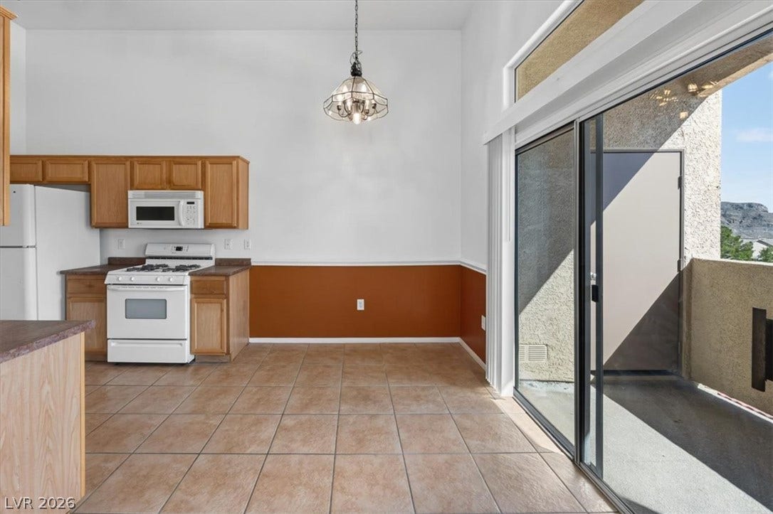 Sliding glass doors open from the tiled dining area directly onto a private balcony.