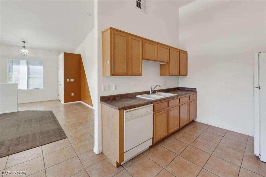 An open floorplan seamlessly connects the functional kitchen space to the adjoining living areas.
