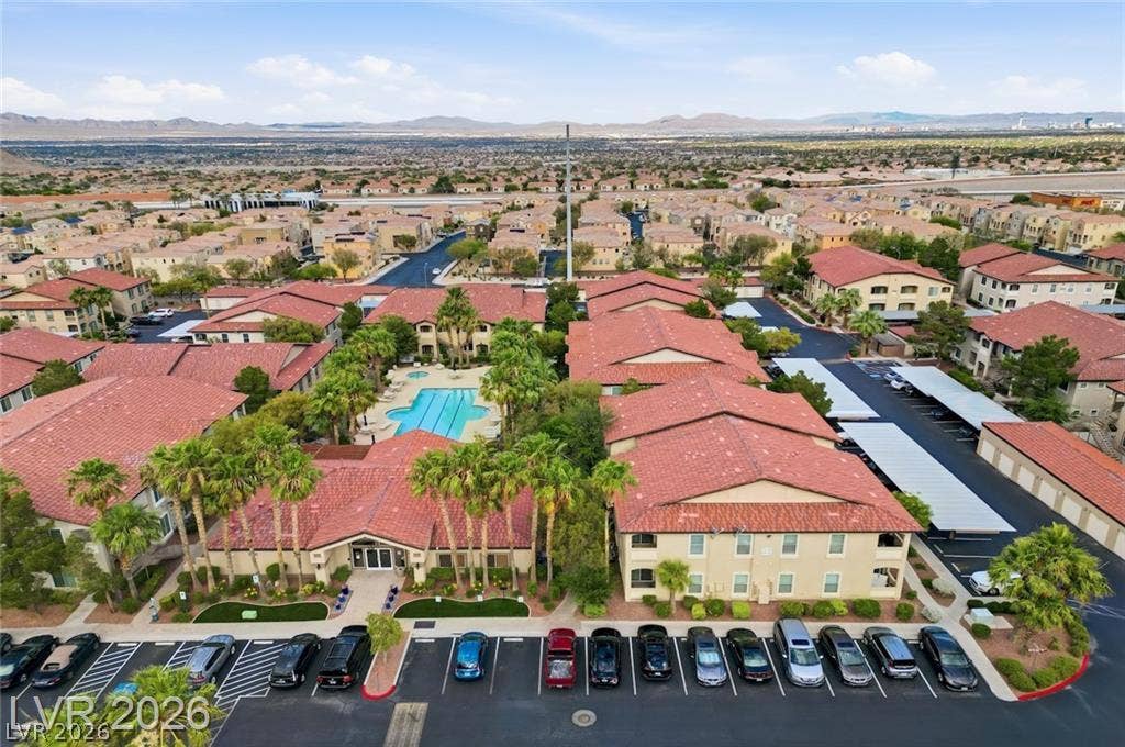 A sweeping aerial view showcases the community recreation area alongside tile-roofed residences.