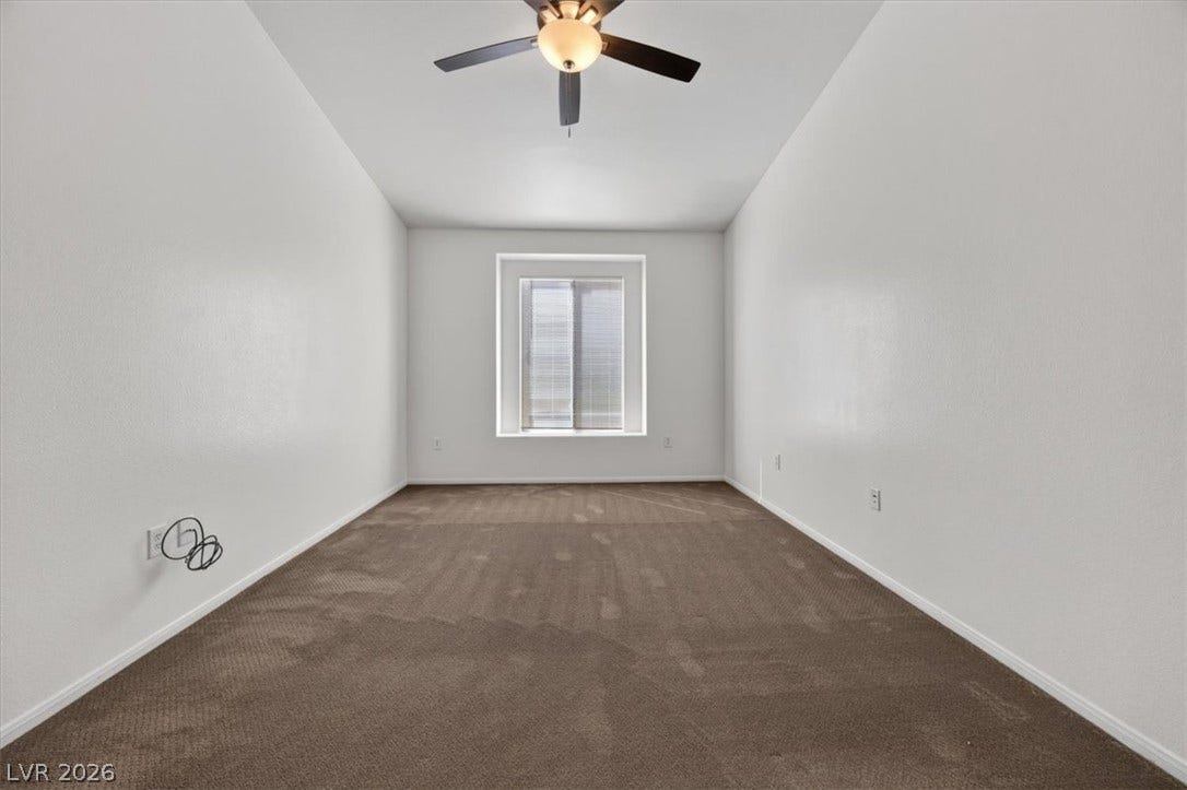 Plush carpeting and a deeply recessed window define this minimalist interior space.