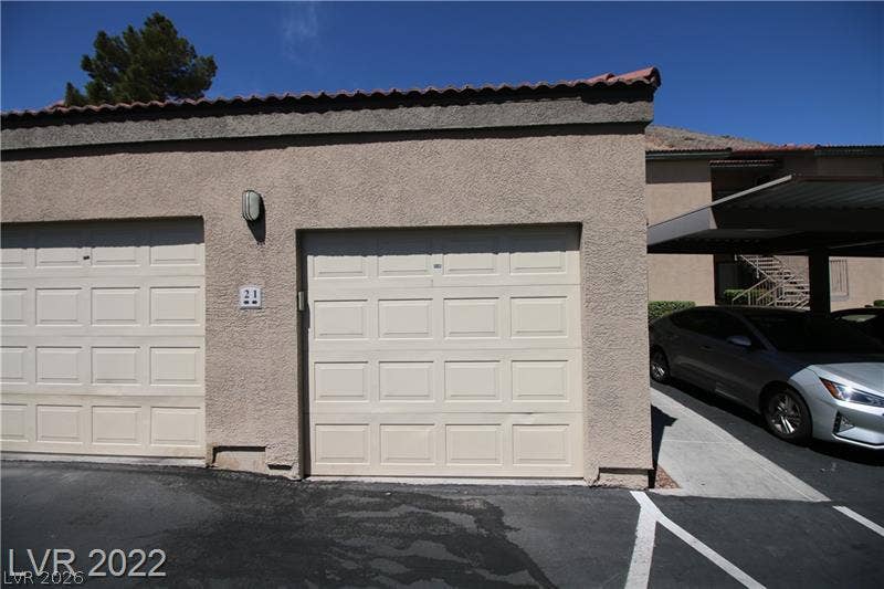 Secure garage parking is nestled beneath a durable Spanish tile roofline.